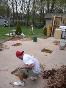 contract worker setting sonotube piers