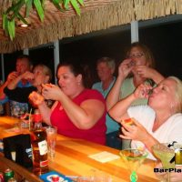 friends doing a shot at home tiki bar