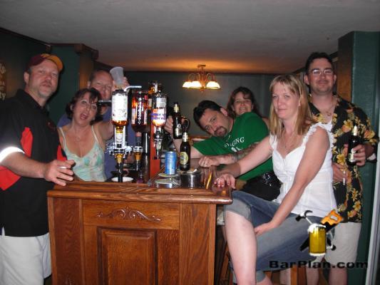 group of people sitting around home bar
