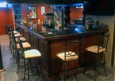 l-shaped home bar in basement