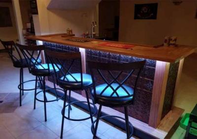 wet bar with chairs and bar lighting